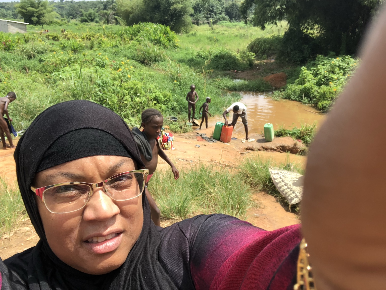 Community members collecting water at a muddy water source in Côte d’Ivoire